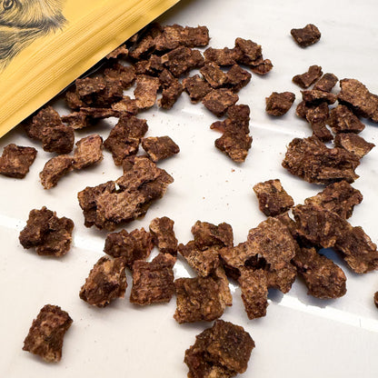 Brown textured air-dried food for dogs. Dry small pieces, but not crumbly. 