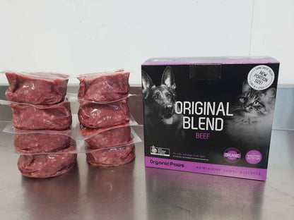 Raw meat packages and a box of 'Original Blend Beef' on a metallic surface.